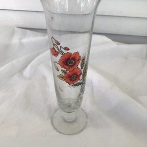 Glass trumpet vase with orange flowers